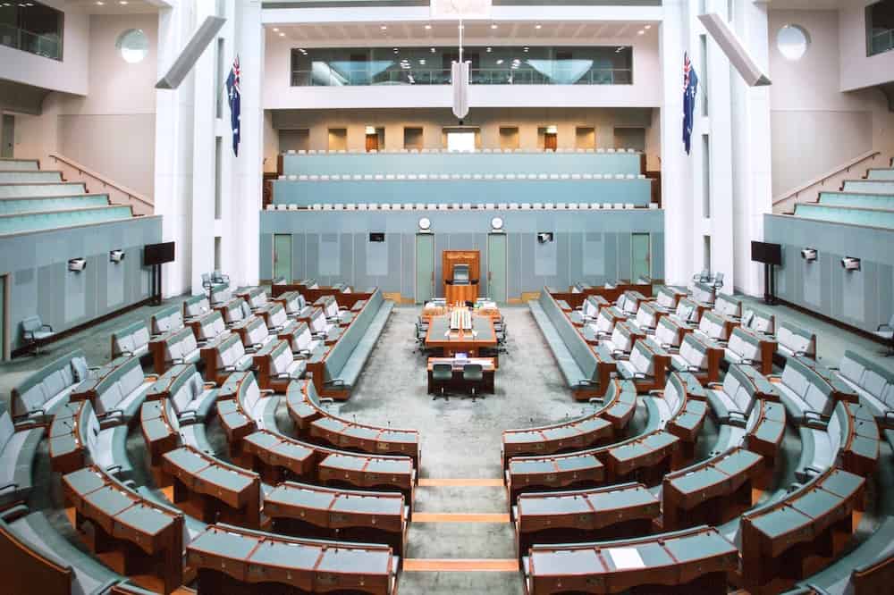 Legislative chamber with tiered desks, seating and presentation positions