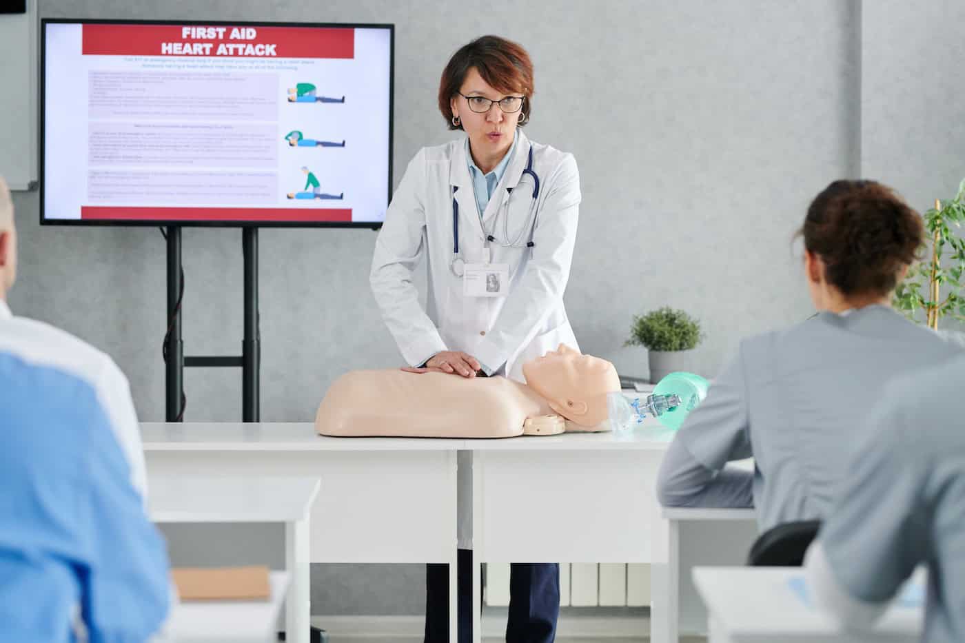 Healthcare training session with a demonstration model and presentation display